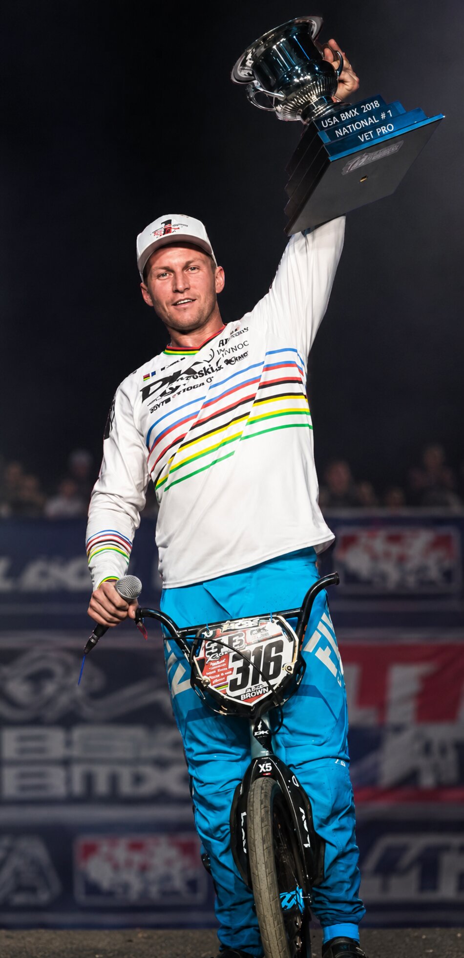 Tyler Brown raising his USA BMX National Number 1 Vet Pro trophy in his world champion jersey